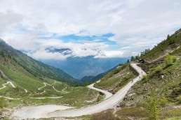 Limited edition fine art cycling print of 3 cyclists riding the gravel hairpins of Colle delle Finestre. The cl famous climb often feature in the Giro d'italia Shot for Cyclist Magazine by Patrik Lundin - cycling prints, fine art cycling print, limited edition prints, limited edition cycling prints, cycling photos, cycling images, cyclist, hairpin, hairpin road, cycling, cyclist magazine, gift, gift for cyclists